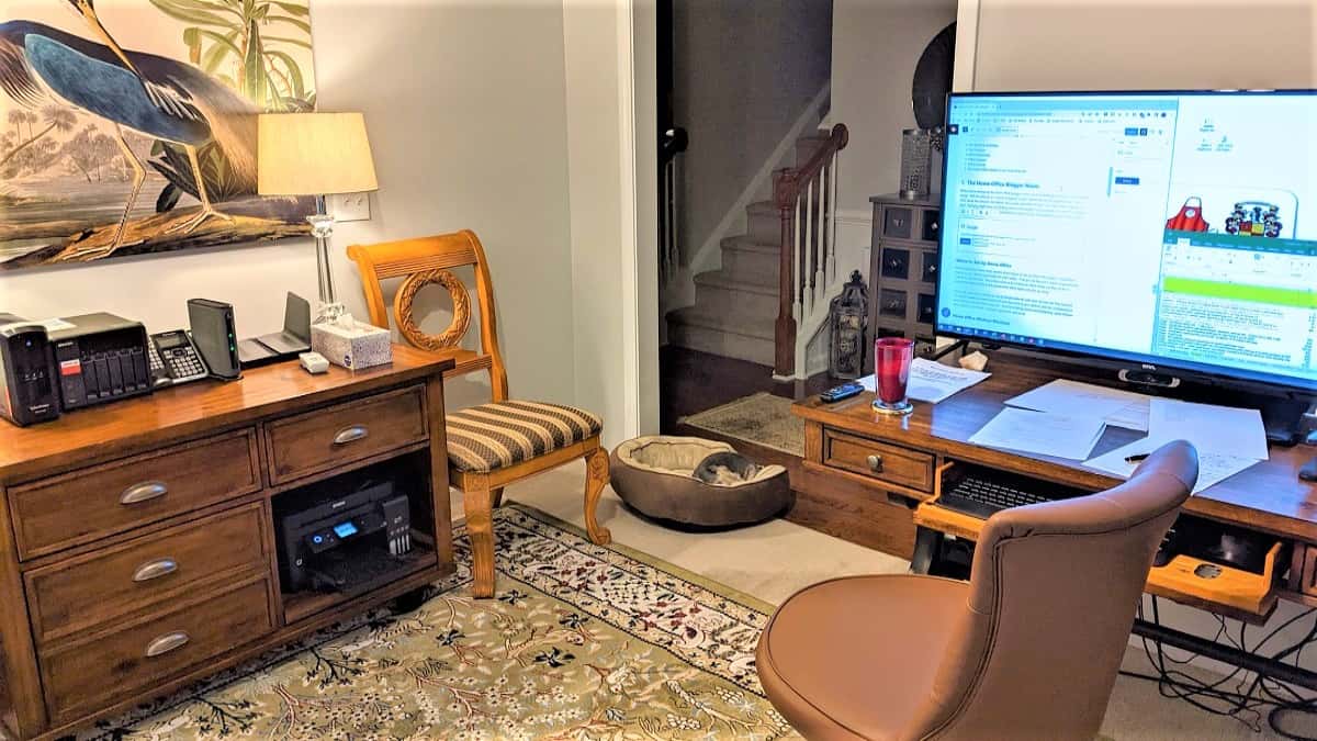 Home office layout with desk, monitor, NAS, and ergonomic chair